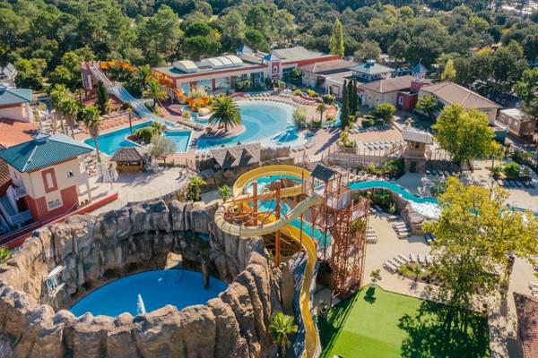 Aerial view of Camping Village Sylvamar with a sunset in the background.