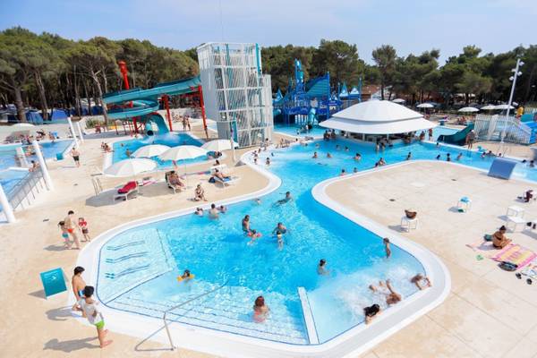 Aerial view of Camping Cikat water park with pools and slides at sunset.