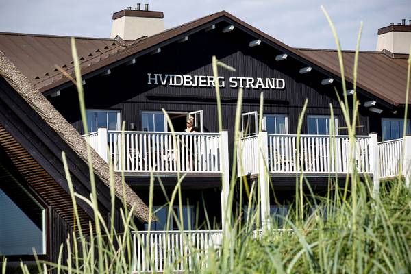 Hvidbjerg Strand Feriepark Gebäude mit Balkon, eine Frau steht auf dem Balkon