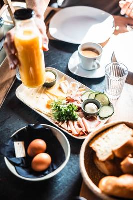 Desayuno en Alpencamping Nenzing con queso, huevos y café en la mesa.