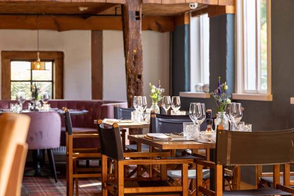Indre udsigt af restauranten i Vakantiepark De Twee Bruggen med dækkede borde og stole.