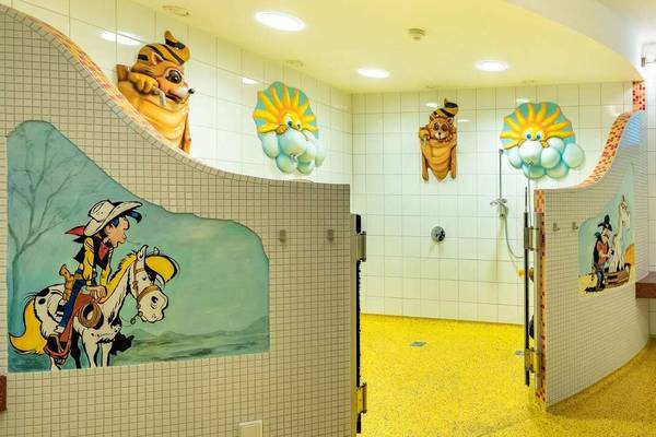Children's bathroom at Erlebnis Resort Aufenfeld with cartoon character murals and playful fixtures.