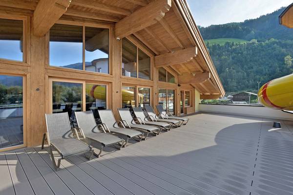 Terrace with lounge chairs at Erlebnis Resort Aufenfeld, wooden chalet, mountain view