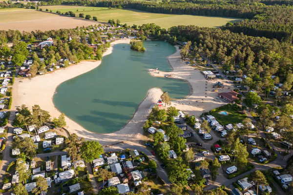 Luftfoto af Südsee-Camp camping med mange autocampere ved bredden af en sø
