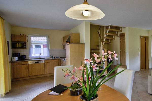 Interior of Camping- und Ferienpark Havelberge with living room, dining table, and kitchen