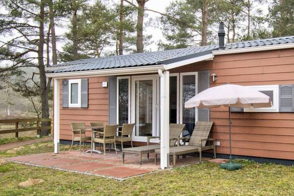 Holiday home in Camping and Holiday Park Havelberge with terrace and umbrella.