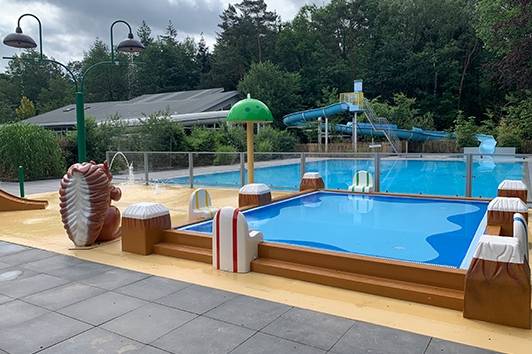 Camping De Wildhoeve swimming pool and slide on a cloudy day