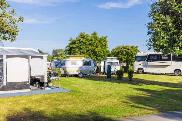 Camping Insel-Camp Fehmarn con varias autocaravanas y caravanas en un campo de césped.