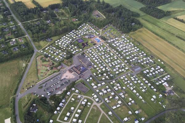 Aerial view of Jambo Feriepark campsite with many tents, buildings, and green fields.