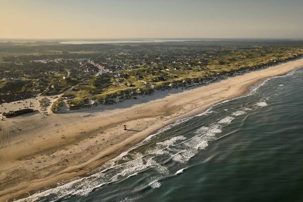 Aerial view of Henne Strand Resort showing the beach, dunes, and coastal town.