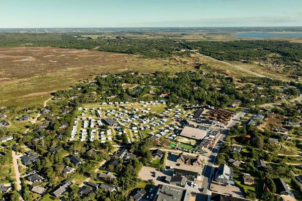 Aerial view of Henne Strand Resort with many houses and parked cars.