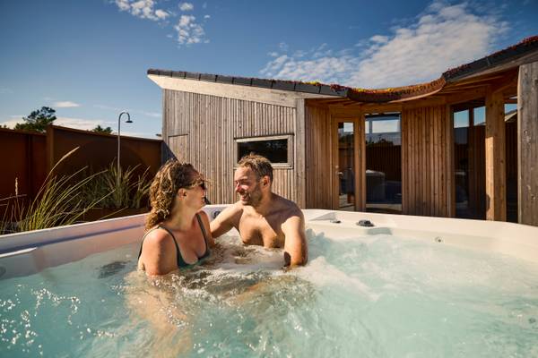 Couple relaxing in a hot tub at Henne Strand Resort