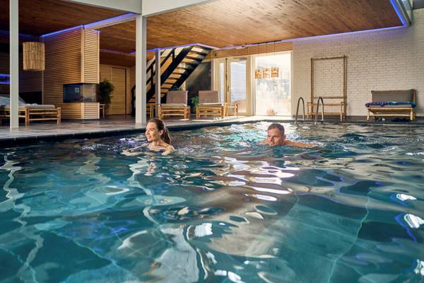 A couple swimming in the pool at the Henne Strand Resort