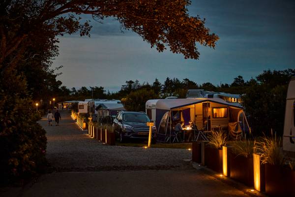 Henne Strand Resort campsite with tents and cars parked in rows at night