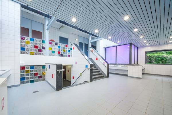 Interior of Camping De Paal with tiled floors and colorful mosaic wall decorations.