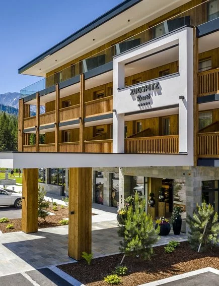 Entrance of the Zugspitz Resort with wooden balconies and a mountain view